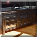 F04. Media console with glass doors. 28.5"h x 64.5"w x 23.5"d 